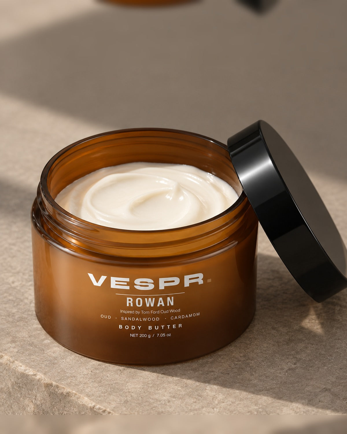 Open jar of VESPR body butter showing its dense, whipped texture